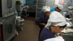Three young students in cooking class wear aprons enjoyment while taking  selfie photo with mobile phone in kitchen, smiling and laughing, preparing  eggs and fruits, learn fun culinary course together. 7427729 Stock